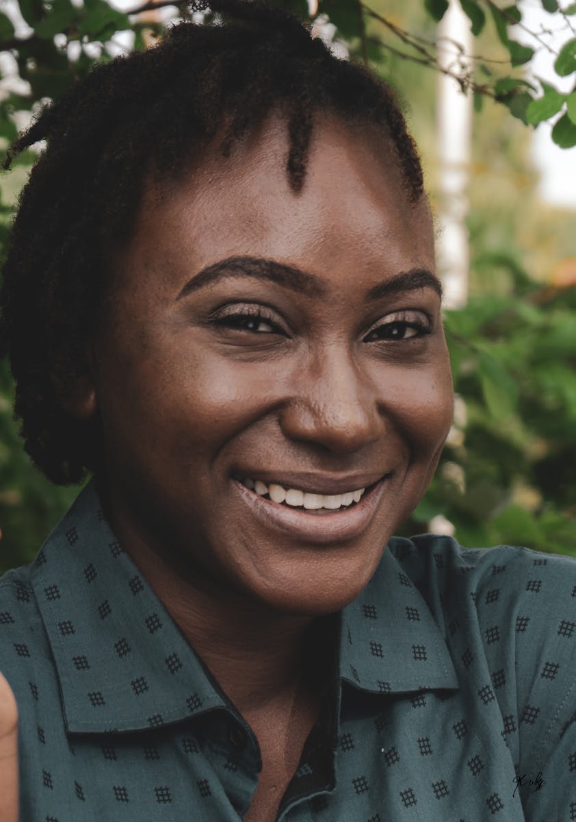 A smiling woman with a green shirt and a green shirt
